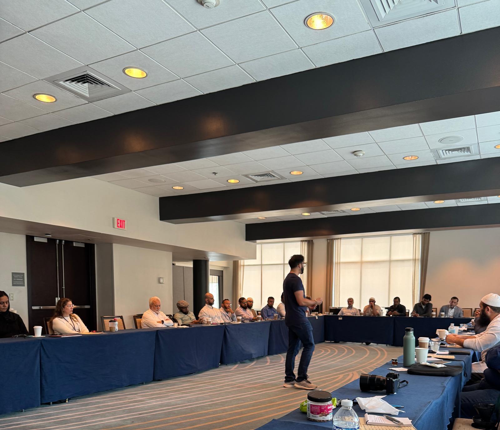 Facilitator leading a program management session in a conference room
