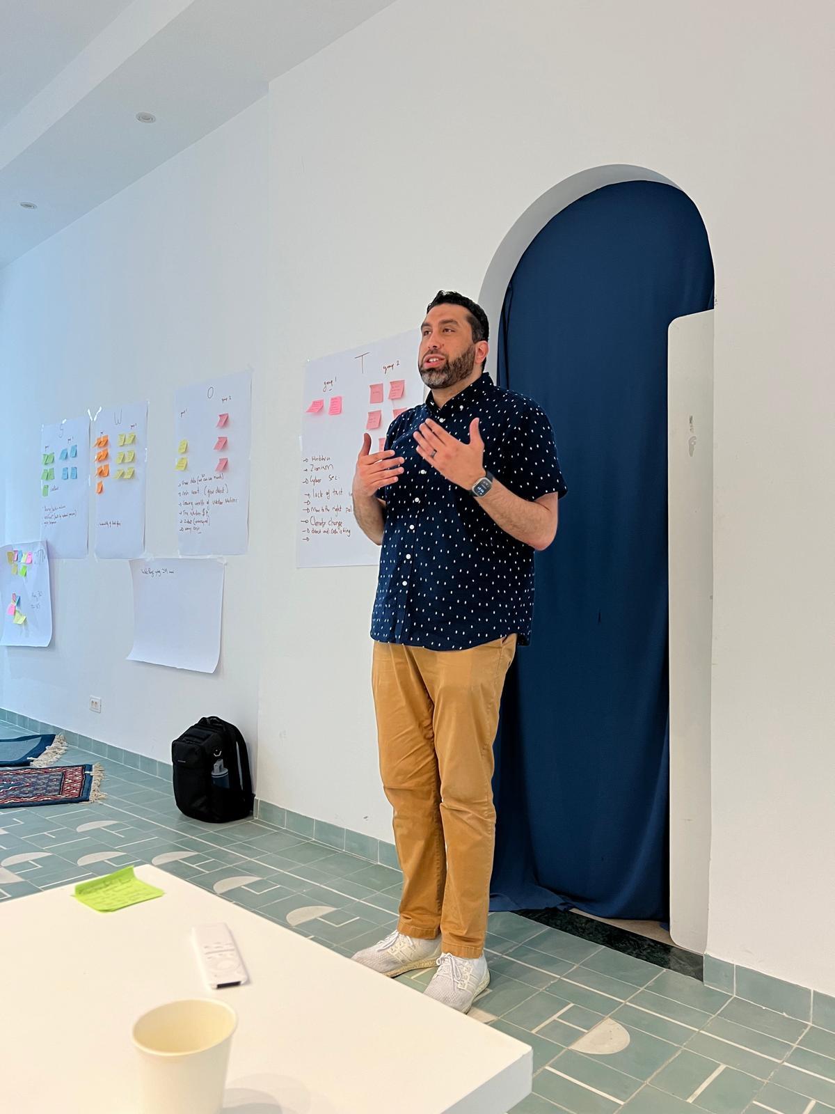 Sharif Aly leading a strategic planning workshop with SWOT analysis